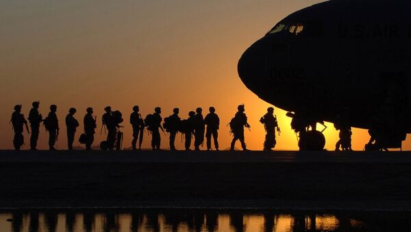 The sun sets behind a C-17 Globemasterat Joint Base Balad, Iraq, as Soldiers begin boarding - Sputnik International