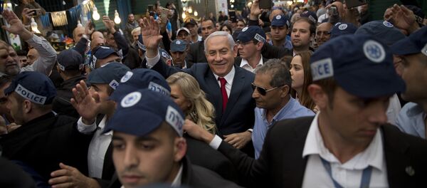 Israeli Prime Minister and head of the Likud party Benjamin Netanyahu, center, is escorted by security guards during a visit to the Ha'tikva market in Tel Aviv, Israel, Tuesday, April 2, 2019 - Sputnik International