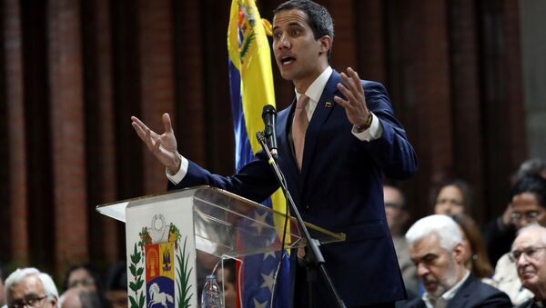 Venezuelan opposition leader Juan Guaido, who many nations have recognized as the country's rightful interim ruler, attends a meeting with political leaders at a university in Caracas, Venezuela April 1, 2019 - Sputnik International