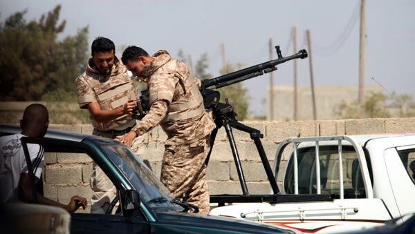 Soldiers from the Libyan National Army get ready to enter Rafallah al-sahati Islamic Militia Brigades compound, one of the compound buildings can be seen behind the wall, in Benghazi, Libya, Saturday, Sept. 22, 2012.  - Sputnik International