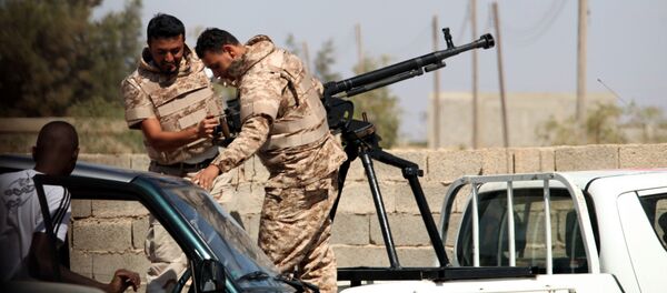 Soldiers from the Libyan National Army get ready to enter Rafallah al-sahati Islamic Militia Brigades compound, one of the compound buildings can be seen behind the wall, in Benghazi, Libya, Saturday, Sept. 22, 2012. - Sputnik International