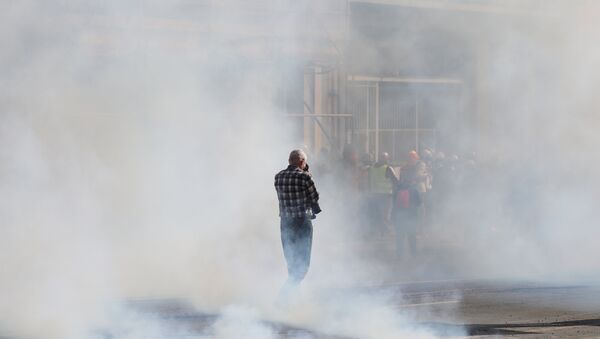 A man stands in tear-gas smoke during a Yellow Vests (Gilets Jaunes) protest in Rouen on April 6, 2019 as demonstrations are planned by the Yellow Vest movement for the 21st consecutive Saturday - Sputnik International
