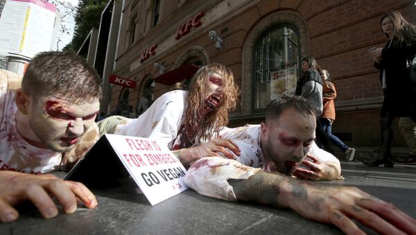 Members of People for the Ethical Treatment of Animals (PETA) dressed as zombies as they lay on the ground amid pedestrians in front of a fast food restaurant in Sydney, Thursday, April 15, 2017 - Sputnik International