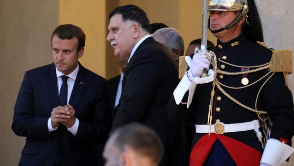 French President Emmanuel Macron (L) gestures as he speaks with the head of the Libyan unity government Fayez al-Sarraj (C) following a meeting with EU and African leaders to discuss how to ease the European Union's migrant crisis, at The Elysee Palace in Paris on August 28, 2017 - Sputnik International