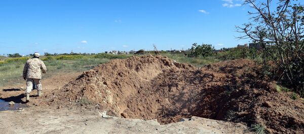 A crater is seen at the blast site after an air strike at Mitiga airport in Tripoli, Libya April 8, 2019 A crater is seen at the blast site after an air strike at Mitiga airport in Tripoli, Libya April 8, 2019 - Sputnik International