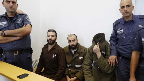 French national Romain Franck (R), 24, a worker at the French consulate, and Palestinian Moufak al-Ajluni (L) and Mohamed Katout (C) appear in court the southern Israeli city of Beer Sheva on March 19, 2018, to face charges of smuggling guns from Gaza - Sputnik International