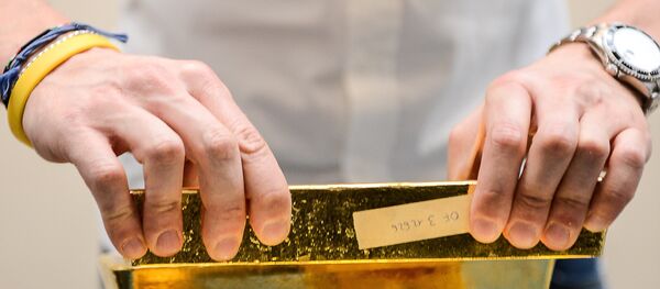A metal analyst controls the weight of gold bars after the melting of gold, at Italpreziosi gold refinery company, in Arezzo, on 11 May, 2012 A metal analyst controls the weight of gold bars after the melting of gold, at Italpreziosi gold refinery company, in Arezzo, on 11 May, 2012 - Sputnik International