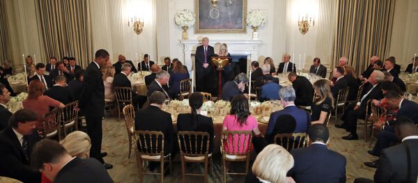 President Donald Trump bows his head in prayer as pastor Paula White leads the room in prayer during a dinner for evangelical leaders in the State Dining Room of the White House, Monday, Aug. 27, 2018, in Washington.  - Sputnik International