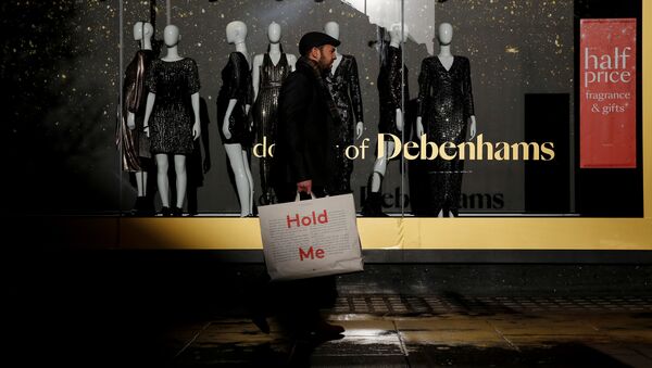 Shoppers walk past a window display at the Debenhams department store on Oxford Street in London - Sputnik International