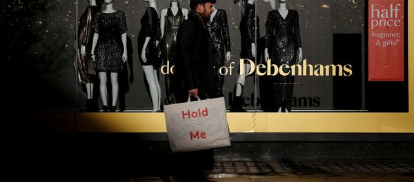 Shoppers walk past a window display at the Debenhams department store on Oxford Street in London - Sputnik International