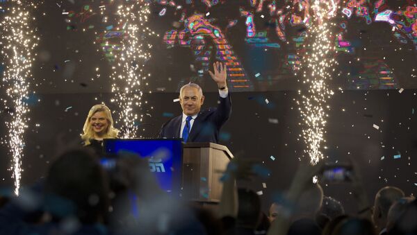 Israel's Prime Minister Benjamin Netanyahu accompanied by his wife Sara waves to his supporters after polls for Israel's general elections closed in Tel Aviv, Israel, Wednesday, April 10, 2019 - Sputnik International
