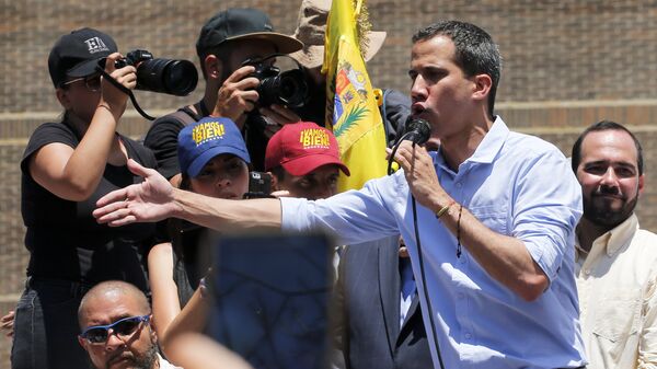 Opposition leader and self-proclaimed interim president Juan Guaido speaks to supporters during a rally to protest outages that left most of the country scrambling for days in the dark in Caracas, Venezuela, Saturday, April 6, 2019 - Sputnik International