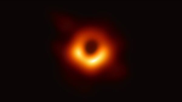 A handout photo provided by the European Southern Observatory on April 10, 2019 shows the first photograph of a black hole and its fiery halo, released by Event Horizon Telescope astronomers (EHT), which is the most direct proof of their existence, one of the project's lead scientists told - Sputnik International