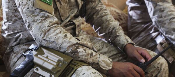 In this Wednesday, Nov. 28, 2018, photograph, an armed Saudi soldier holds a walkie-talkie near Mukalla, Yemen, at an airport now serving as a military base for the United Arab Emirates. - Sputnik International