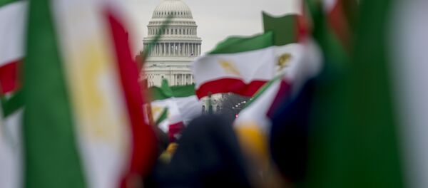 The Dome of the US Capitol building is visible through Iranian flags during an Organisation of Iranian-American Communities rally at Freedom Plaza in Washington, Friday, 8 March 2019. (AP Photo/Andrew Harnik) - Sputnik International