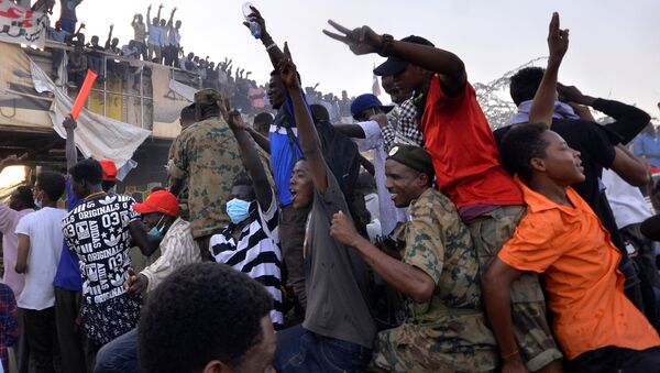 Sudanese demonstrators ride on a military truck as they chant slogans during a protest rally demanding Sudanese President Omar Al-Bashir to step down, outside Defence Ministry in Khartoum, Sudan April 9, 2019 - Sputnik International