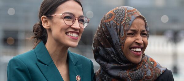 US Representative Alexandria Ocasio-Cortez, Democrat of New York, and US Representative Ilhan Omar (R), Democrat of Minnesota, attend a press conference calling on Congress to cut funding for US Immigration and Customs Enforcement (ICE) and to defund border detention facilities, outside the US Capitol in Washington, DC, February 7, 2019. US Representative Alexandria Ocasio-Cortez, Democrat of New York, and US Representative Ilhan Omar (R), Democrat of Minnesota, attend a press conference calling on Congress to cut funding for US Immigration and Customs Enforcement (ICE) and to defund border detention facilities, outside the US Capitol in Washington, DC, February 7, 2019. - Sputnik International