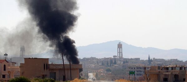 Smoke rises from Taybat al Imam town after rebel fighters from the hardline jihadist Jund al-Aqsa advanced in the town in Hama province, Syria August 31, 2016.(archives) - Sputnik International