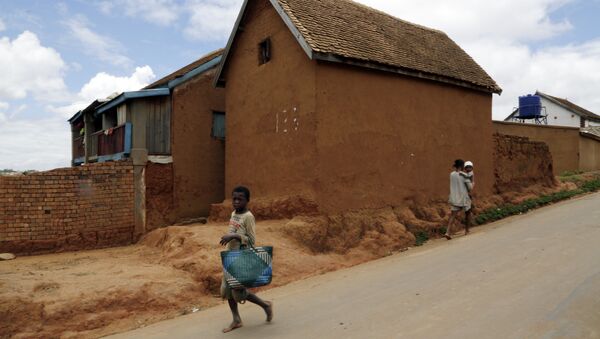 A young girl runs past a house in Antananarivo, Madagascar - Sputnik International