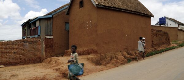 A young girl runs past a house in Antananarivo, Madagascar - Sputnik International