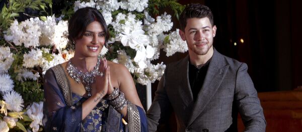 Bollywood actress Priyanka Chopra and musician Nick Jonas pose for photographs at their wedding reception in Mumbai, India, Wednesday, Dec 19, 2018 - Sputnik International