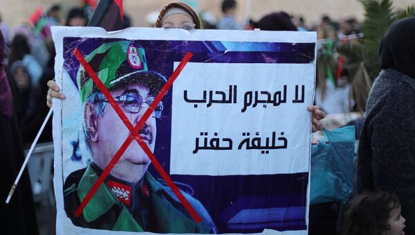 Libyan protesters attend a demonstration to demand an end to the Khalifa Haftar's offensive against Tripoli, in Martyrs Square in central Tripoli, Libya, 12 April, 2019 - Sputnik International