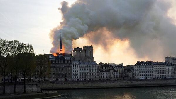 Smoke billows from the Notre Dame Cathedral after a fire broke out, in Paris, France, April 15, 2019. - Sputnik International