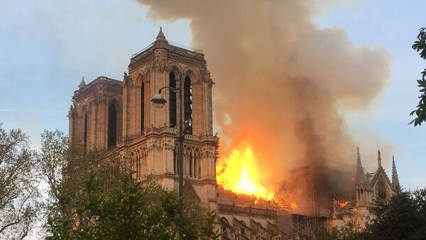 Fire engulfs the iconic Notre Dame cathedral in Paris. - Sputnik International