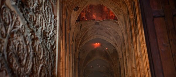 Flames and smoke are seen as the interior continues to burn inside the Notre Dame Cathedral in Paris, France, April 16, 2019. Flames and smoke are seen as the interior continues to burn inside the Notre Dame Cathedral in Paris, France, April 16, 2019. - Sputnik International