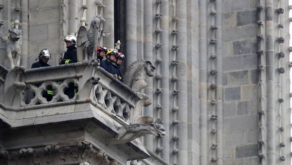 Firefighters work at Notre-Dame Cathedral in Paris, France April 16, 2019 - Sputnik International