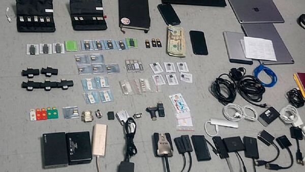 This Friday, April 12, 2019 handout photo provided by the State Attorney General's Office, shows items confiscated from the Ecuadorian residence of Swedish programmer Ola Bini, who was arrested Thursday, April 11, 2019, at the airport in Quito, Ecuador, while preparing to board a flight to Japan. - Sputnik International