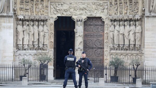 French police officers stand outside Notre-Dame-de Paris on April 16, 2019 in Paris in the aftermath of a fire that devastated the cathedral - Sputnik International
