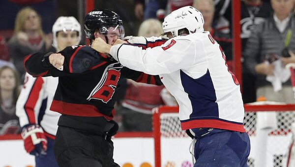 Washington Capitals' Alex Ovechkin, right, of Russia, punches Carolina Hurricanes' Andrei Svechnikov, also of Russia, during the first period of Game 3 of an NHL hockey first-round playoff series in Raleigh, N.C., Monday, April 15, 2019. - Sputnik International
