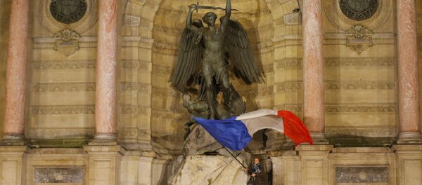 People attend a vigil in Paris, Tuesday April 16, 2019. Firefighters declared success Tuesday in a more than 12-hour battle to extinguish an inferno engulfing Paris' iconic Notre Dame cathedral that claimed its spire and roof, but spared its bell towers and the purported Crown of Christ. People attend a vigil in Paris, Tuesday April 16, 2019. Firefighters declared success Tuesday in a more than 12-hour battle to extinguish an inferno engulfing Paris' iconic Notre Dame cathedral that claimed its spire and roof, but spared its bell towers and the purported Crown of Christ. - Sputnik International