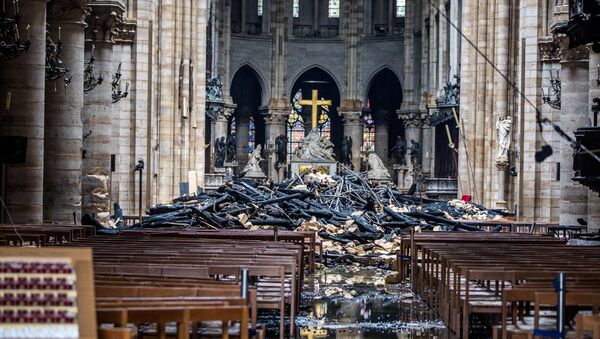 A view of the debris inside Notre-Dame de Paris in the aftermath of a fire that devastated the cathedral, during the visit of French Interior Minister Christophe Castaner (not pictured) in Paris, France, April 16, 2019 - Sputnik International