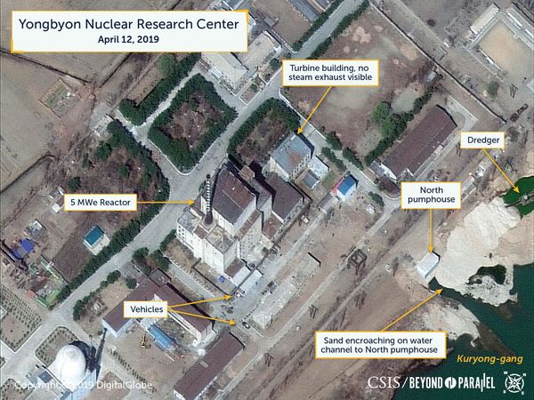 A view of vehicles near the 5MWe reactor and North pumphouse as seen on April 12, 2019. No steam exhaust is visible from the turbine building. A view of vehicles near the 5MWe reactor and North pumphouse as seen on April 12, 2019. No steam exhaust is visible from the turbine building. - Sputnik International