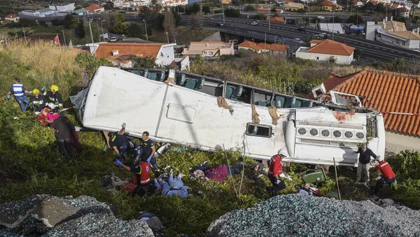 Rescue officials attend the scene after a tour bus crashed in Canico on Portugal's Madeira Island, Wednesday, April 17, 2019. - Sputnik International