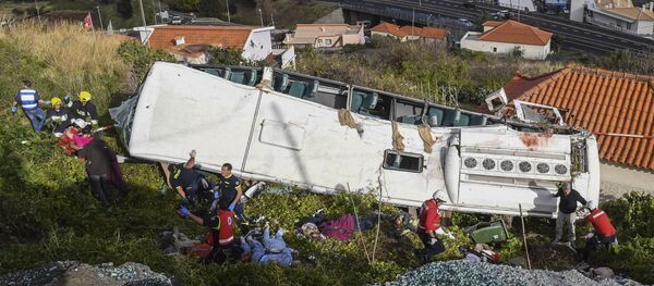 Rescue officials attend the scene after a tour bus crashed in Canico on Portugal's Madeira Island, Wednesday, April 17, 2019. Rescue officials attend the scene after a tour bus crashed in Canico on Portugal's Madeira Island, Wednesday, April 17, 2019. - Sputnik International