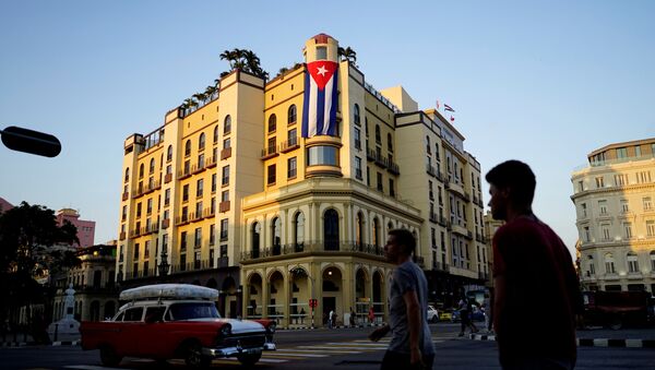 A Cuban flag hangs outside a hotel in Havana, Cuba, April 20, 2018 - Sputnik International
