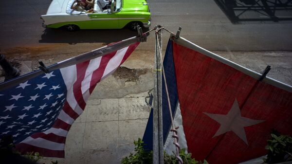 A U.S., and a Cuban national flag, hang from a balcony to mark the restored full diplomatic relations between Cuba and the Unites States, in Old Havana, Monday, July 20, 2015 - Sputnik International