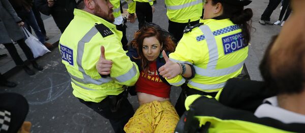 Police carry away a climate change activist protesting at Oxford Circus on the third day of an environmental protest by the Extinction Rebellion group, in London on April 17, 2019. - Sputnik International