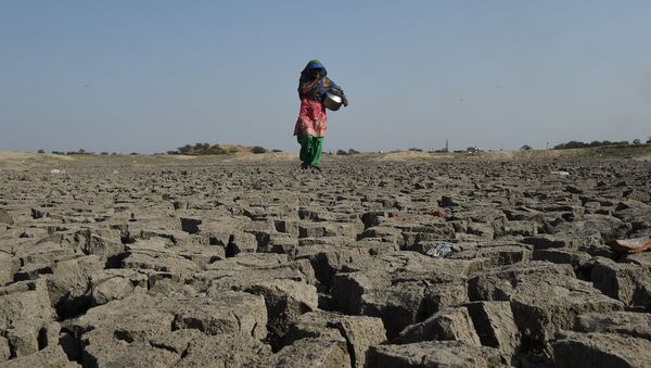 An Indian woman walks over the parched bed of Chandola Lake in Ahmedabad on March 22, 2019, on World Water Day - Sputnik International
