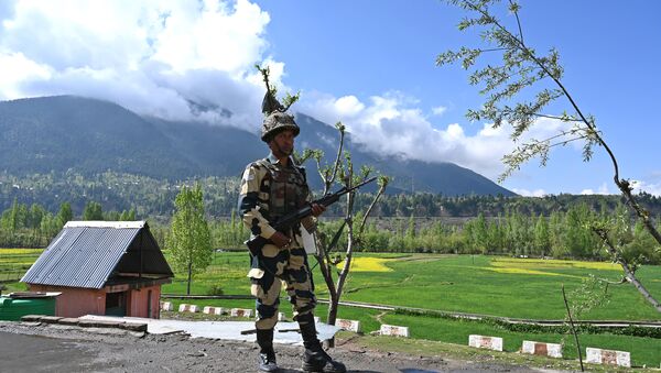 An Indian Border Security Force (BSF) soldier stands guard on the top of a polling station during a second phase of elections at Kangan, some 35 km from Srinagar on April 18, 2019 - Sputnik International
