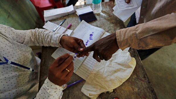 A man gets his finger inked before casting his vote at a polling station in Majuli, a large river island in the Brahmaputra river, in the northeastern Indian state of Assam, India April 11, 2019 - Sputnik International
