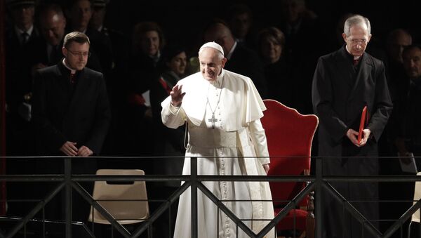 Pope Francis salutes as he arrives during the Via Crucis (Way of the Cross) torchlight procession in front of Rome's Colosseum on Good Friday, a Christian holiday commemorating the crucifixion of Jesus Christ and his death at Calvary, in Rome, Friday, April 19, 2019. - Sputnik International