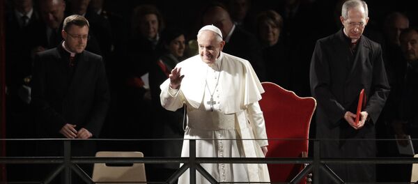 Pope Francis salutes as he arrives during the Via Crucis (Way of the Cross) torchlight procession in front of Rome's Colosseum on Good Friday, a Christian holiday commemorating the crucifixion of Jesus Christ and his death at Calvary, in Rome, Friday, April 19, 2019. Pope Francis salutes as he arrives during the Via Crucis (Way of the Cross) torchlight procession in front of Rome's Colosseum on Good Friday, a Christian holiday commemorating the crucifixion of Jesus Christ and his death at Calvary, in Rome, Friday, April 19, 2019. - Sputnik International