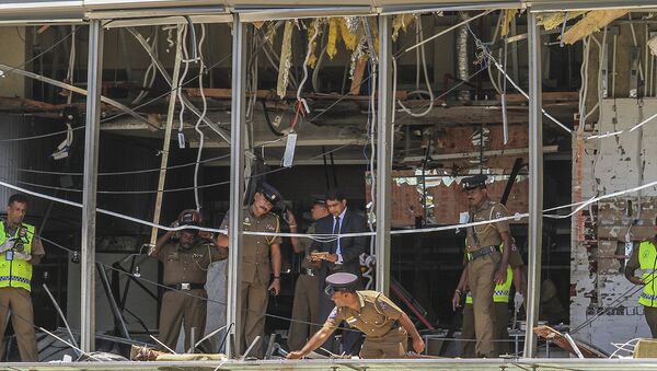 A Sri Lankan Police officer inspects a blast spot at the Shangri-la hotel in Colombo, Sri Lanka, Sunday, April 21, 2019. - Sputnik International
