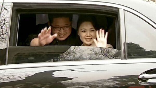 In this image taken from video footage run Wednesday, March 28, 2018, by China's CCTV via AP Video, North Korean leader Kim Jong Un, left, and his wife Ri Sol Ju wave from a car as they bid farewell to Chinese counterpart Xi Jinping and his wife Peng Liyuan in Beijing. - Sputnik International