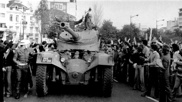 People cheer Portuguese soldiers in a tank driving in Lisbon during the Carnation Revolution in 1974 - Sputnik International