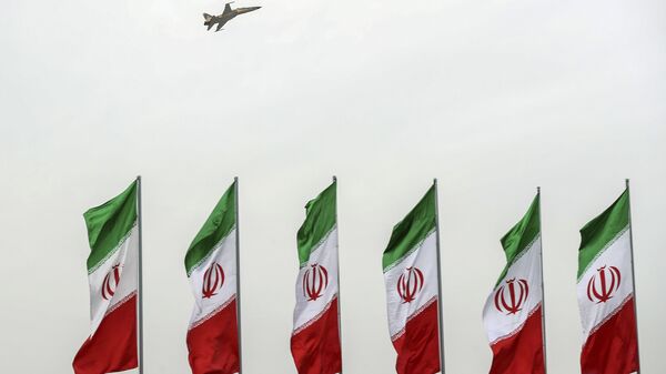In this photo released by the official website of the office of the Iranian Presidency, a fighter jet flies over Iranian flags during the army parade commemorating National Army Day in front of the shrine of the late revolutionary founder Ayatollah Khomeini, just outside Tehran, Iran, Thursday, April 18, 2019 - Sputnik International